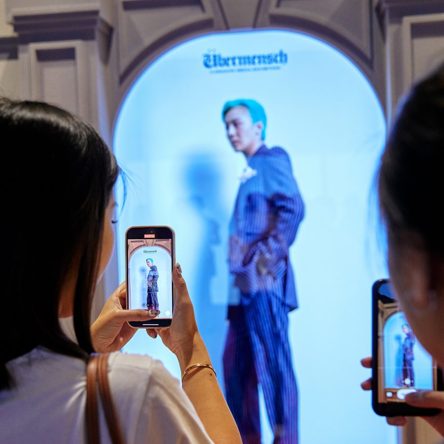 Fans taking photos at the G-Dragon Übermensch exhibition  