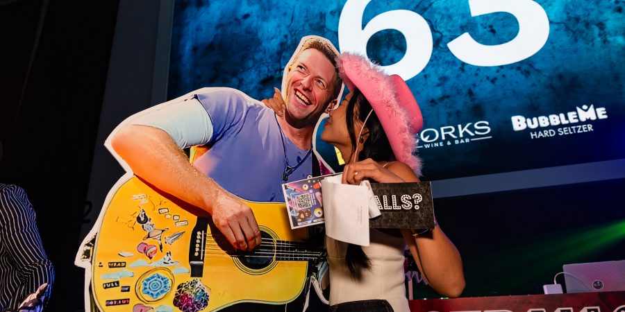 Woman posing with a Chris Martin of Coldplay cut-out at Got Balls in Hong Kong