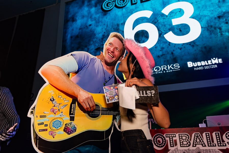 Woman posing with a Chris Martin of Coldplay cut-out at Got Balls? in Hong Kong