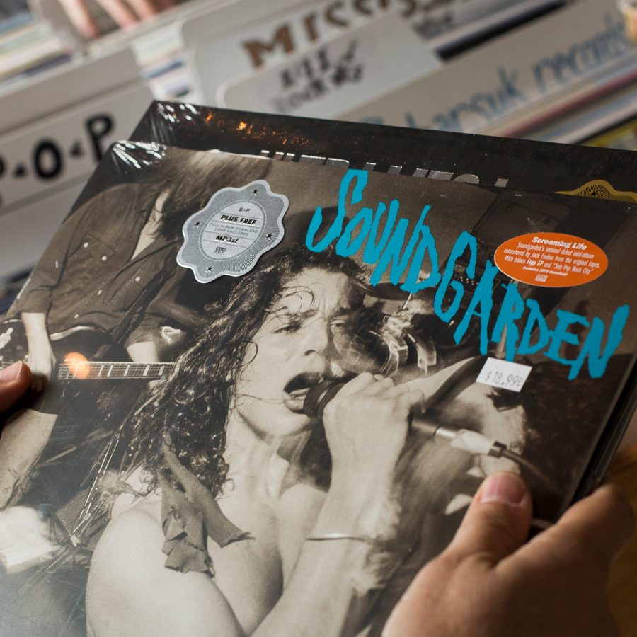 Close-up on a person holding a Soundgarden vinyl in Seattle.