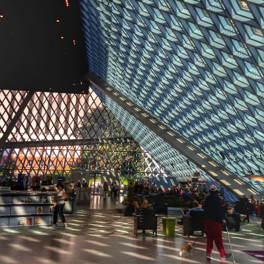Light streams in through geometric glass walls at the Central Library in Seattle.