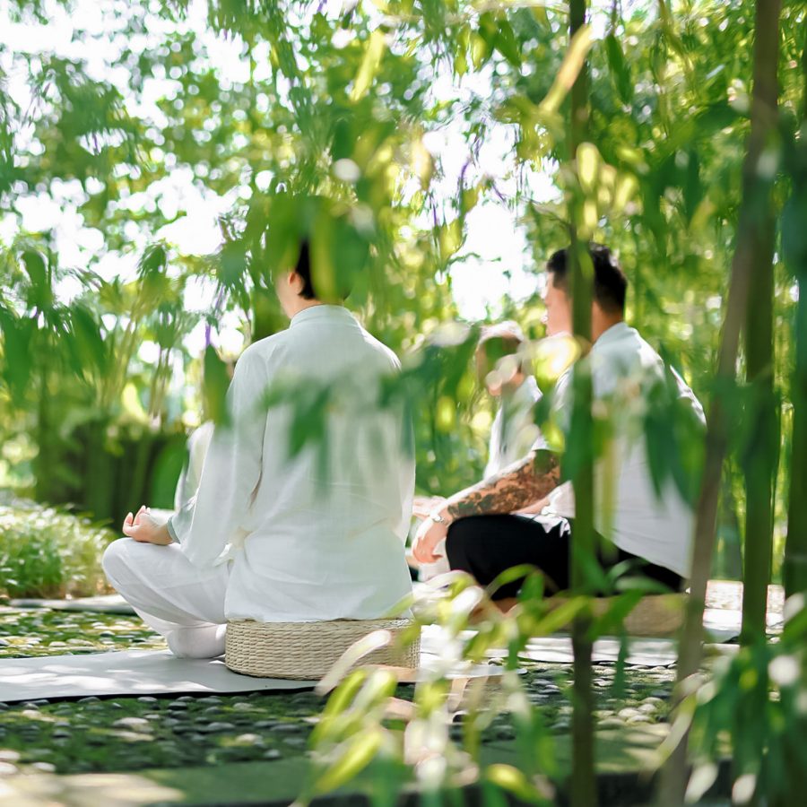 Guests clad in white set against the mountains in the distance at Six Senses Qing Cheng Mountain. / Gu