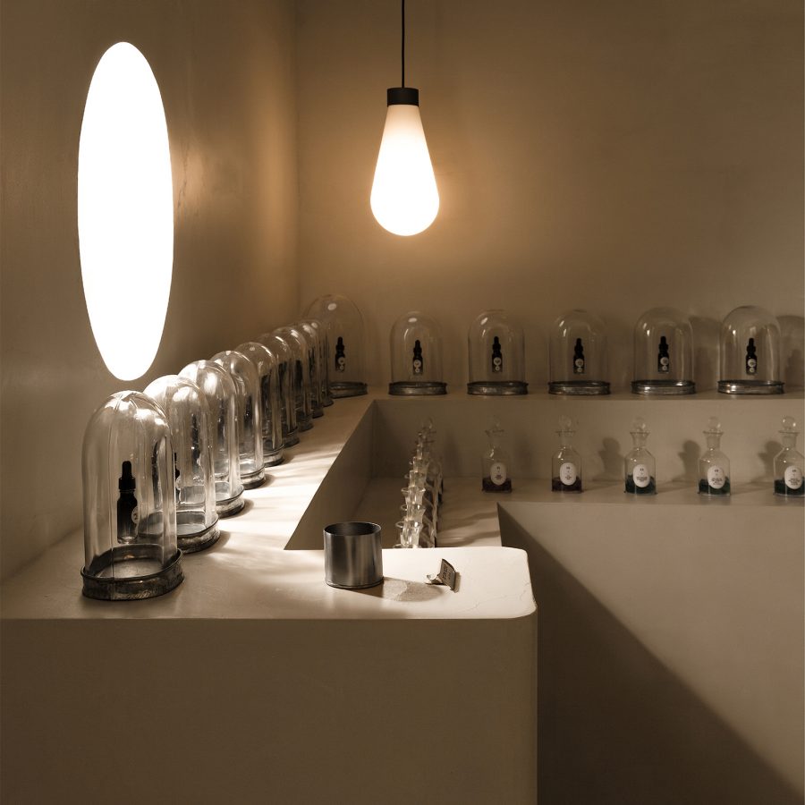 Rows of perfume bottles sit in bell jars at DinShare in Guangzhou.  