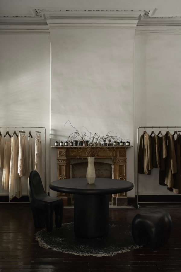 A view of a table, vase and clothing racks at Kar Room in Guangzhou.