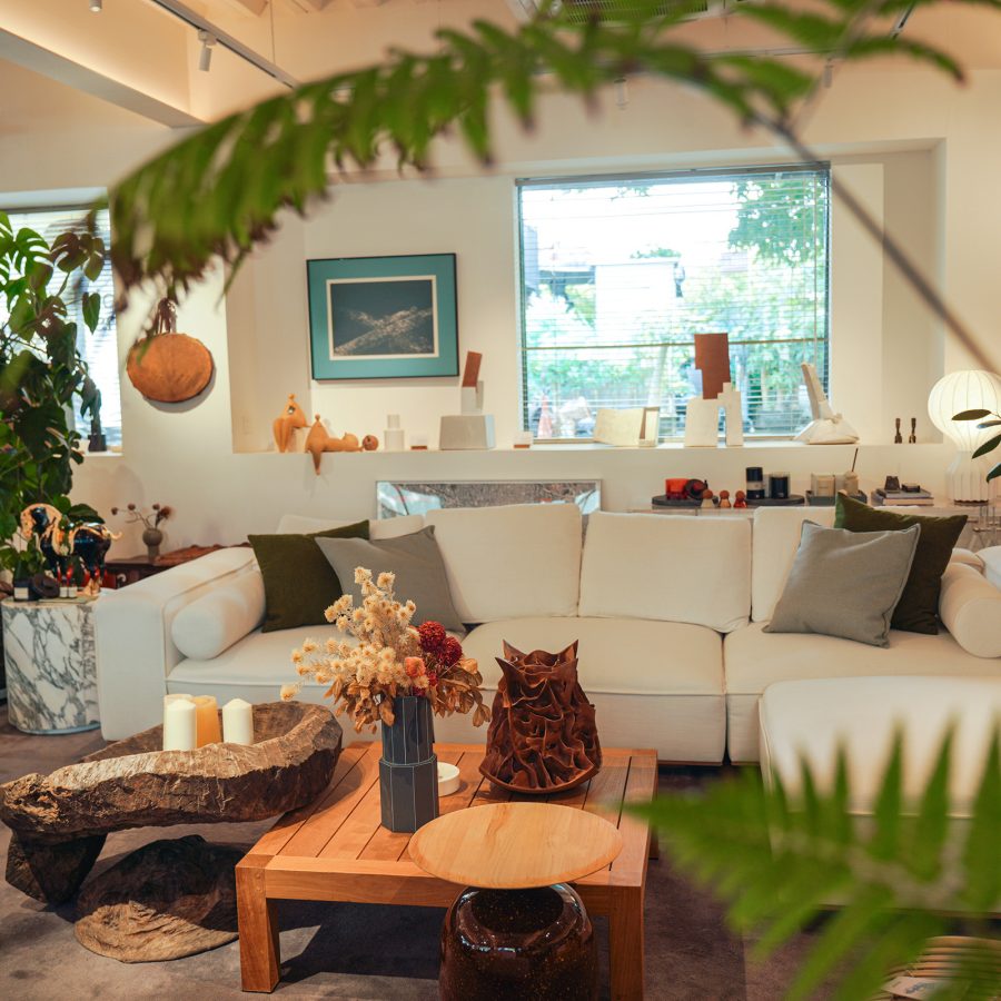 A white couch and styled coffee tables sit in an airy space at Oasis Object in Guangzhou. 