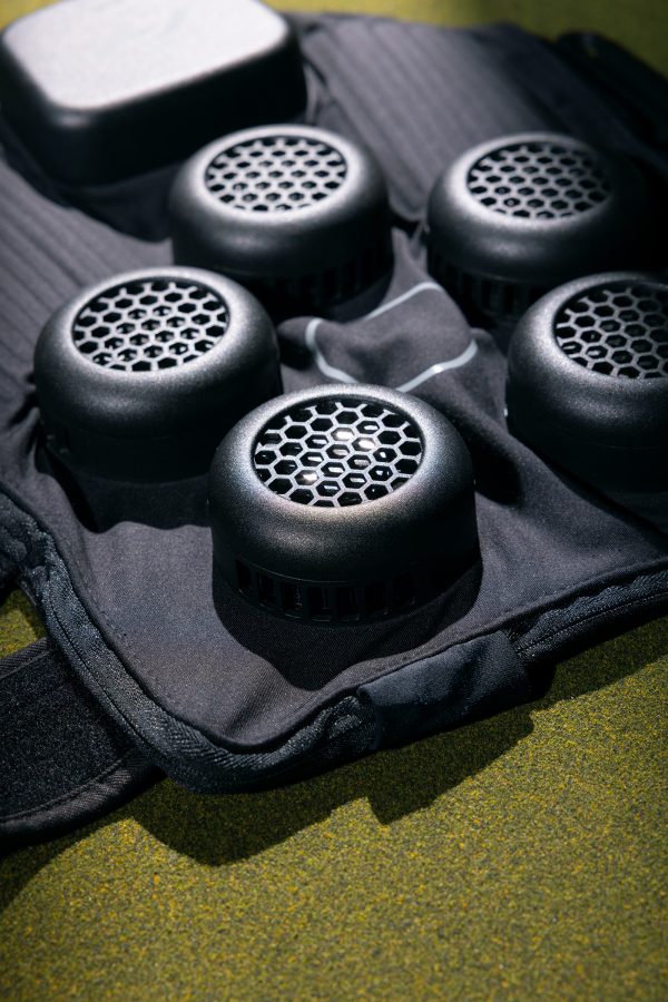 Close-up of the Hyperice X Knee spread out on a green surface. 