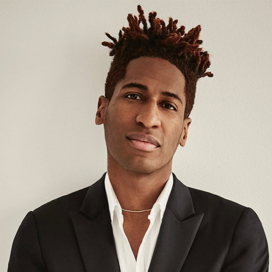 Musician John Batiste poses against a white backdrop.