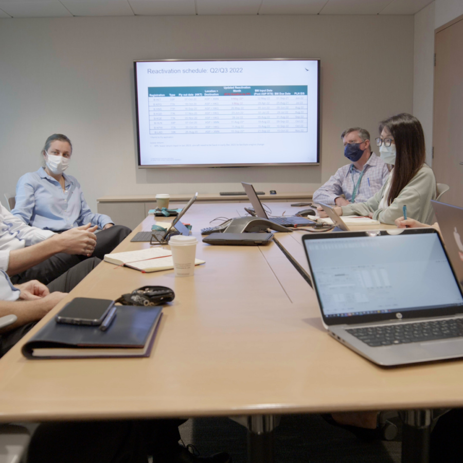 Cathay Pacific meeting with a reactivation schedule for Q2/Q3 2022 shown on a presentation screen.