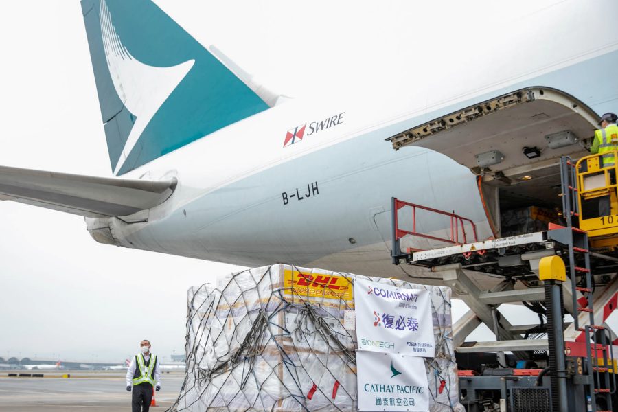 Workers load vaccine shipments onto a Cathay Pacific plane.
