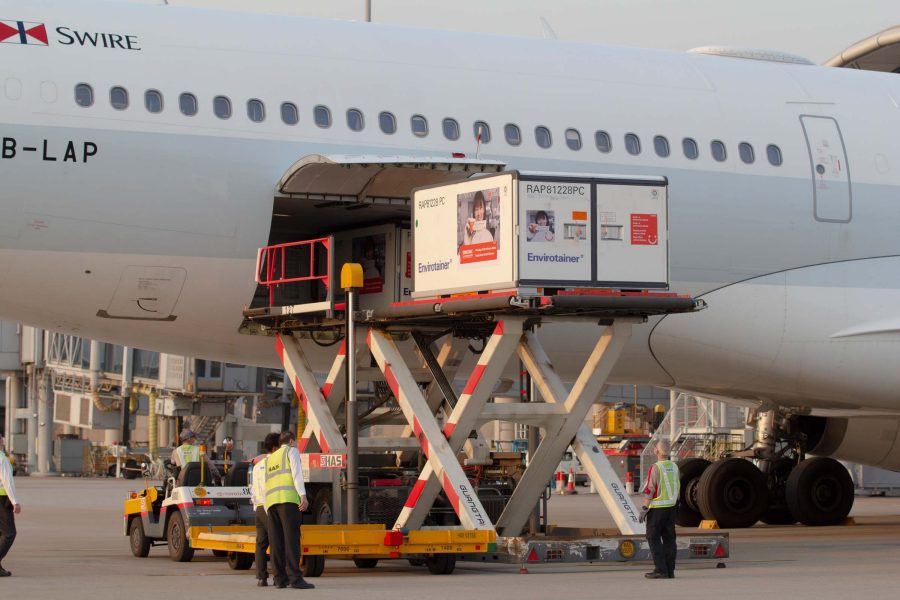 Crew loads temperature-sensitive containers into a Cathay Pacific aircraft
