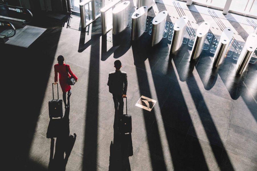 Cathay Pacific cabin crew with suitcases walking through Cathay City lobby.