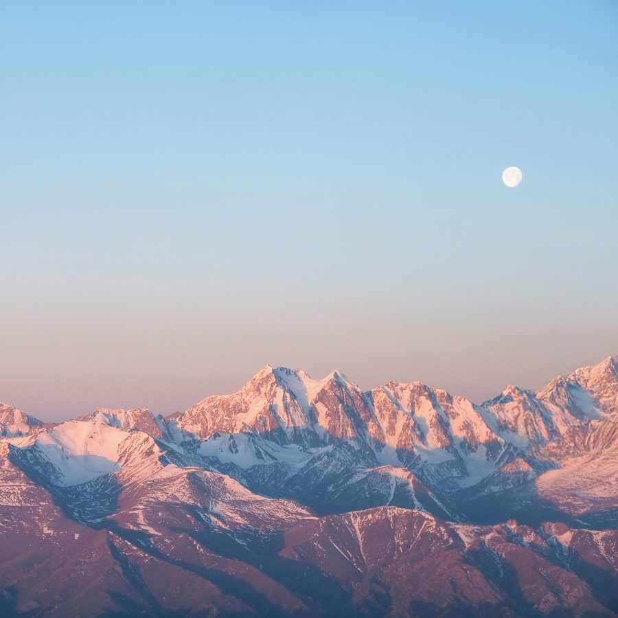 A moon over the Tianshan mountain range.