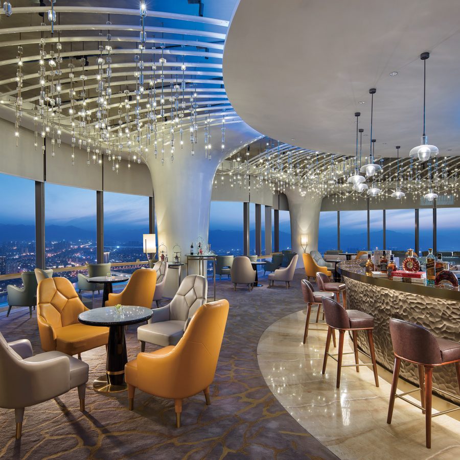 Sky Lounge in Hilton Fuzhou with panoramic views, tables, chairs and bar seating.