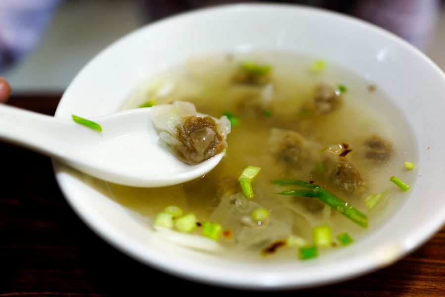 A bowl of soup dumplings with a spoon from Tongli Rouyan Laopu.