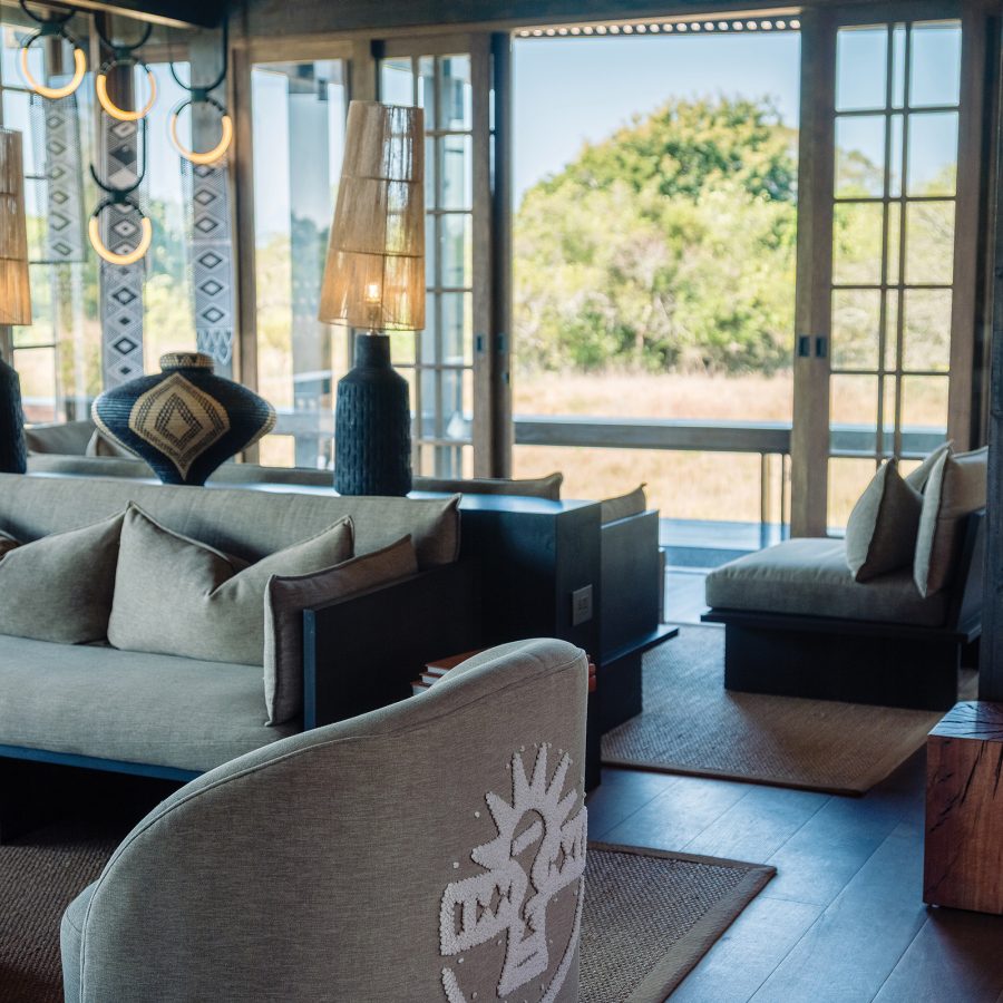The shared area at Phinda Forest Lodge, with stylish couches and earthen ornaments. 