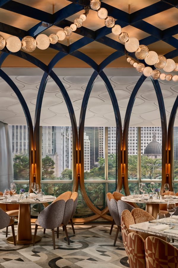 Interiors of Akira Back with a view of Hong Kong through the floor to ceiling glass windows.
