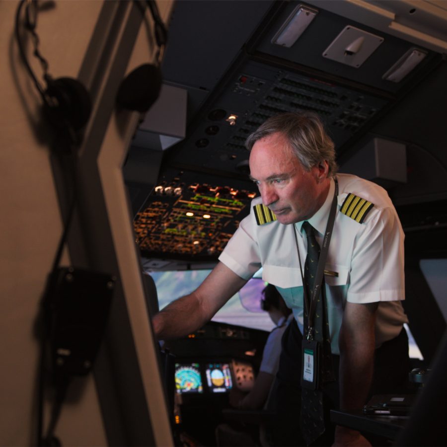 A Cathay Pacific captain looks at instruments in a simulator.