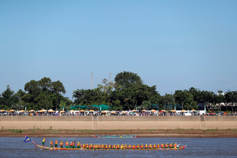 Boats race on the water in Cambodia as part of Bon Om Touk. 