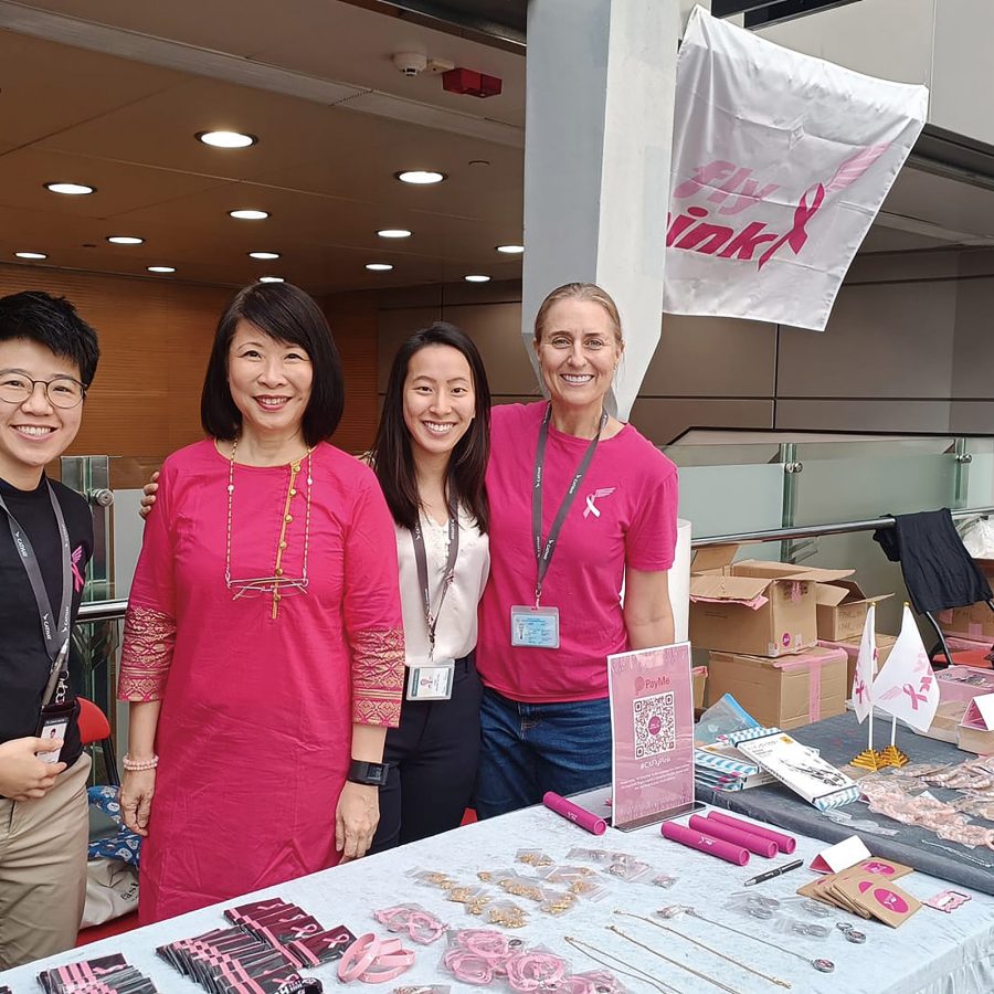 Second Officer Lorraine Leung, Jane Lim, Crew Services Assistant Manager, Second Officer Victoria Tang and Captain Verwey pose for a picture while volunteering at Cathay City.