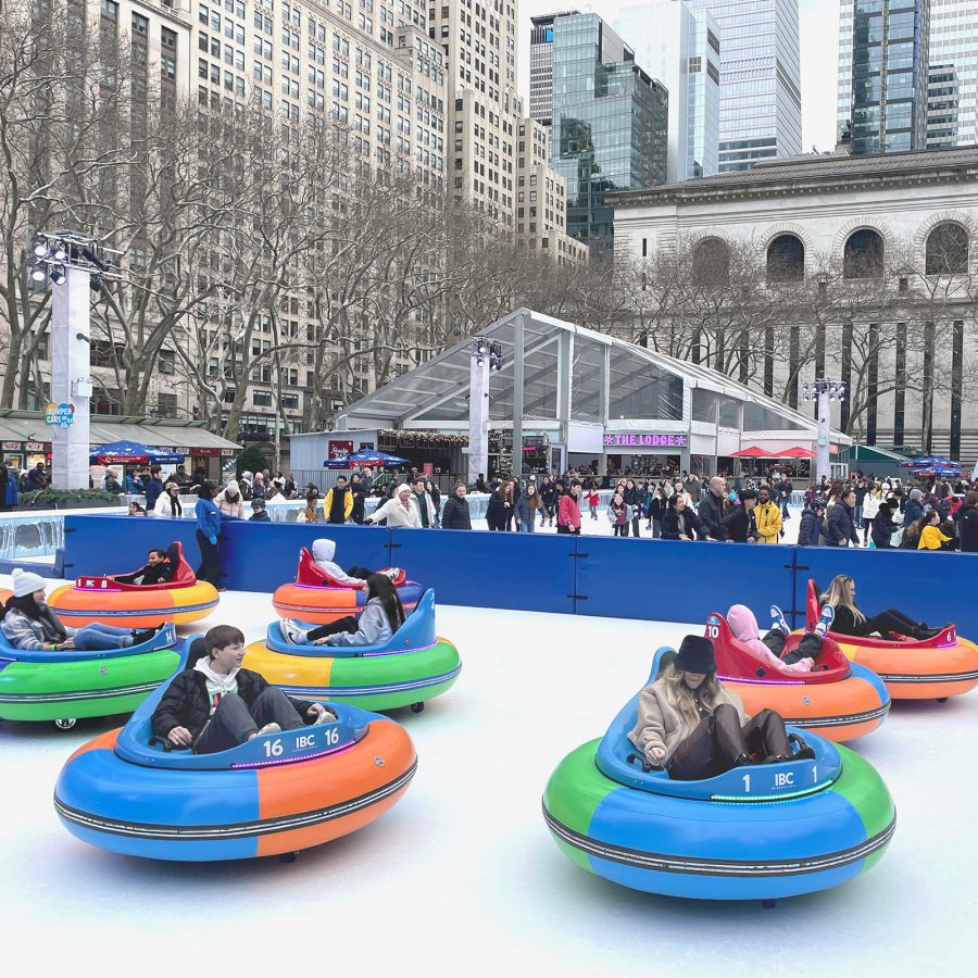 People playing on a fairground ride at a Christmas market in New York.