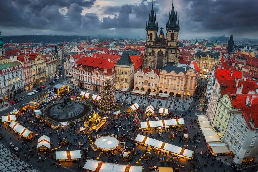 View of one of the Prague Christmas Markets with stalls set up in a square.