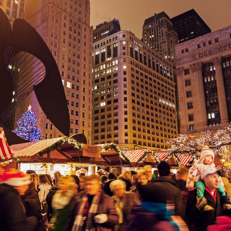 Night-time image of a busy Christmas market filled with people in Chicago.