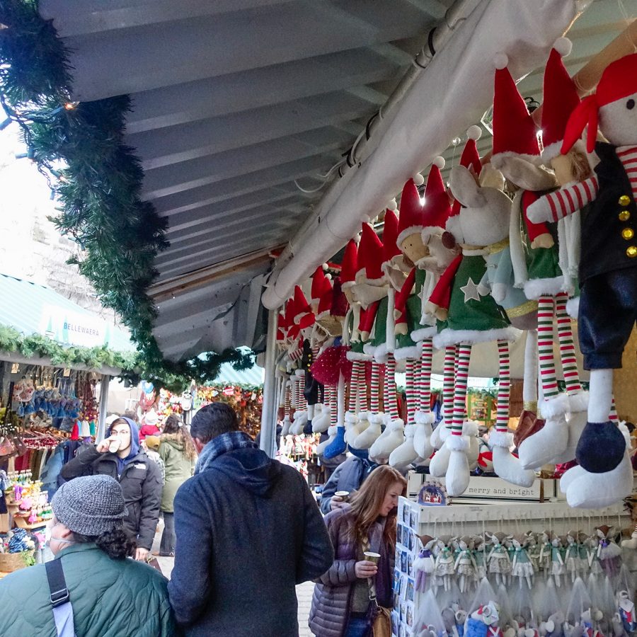Christmas stall full of hanging elf plush toys.