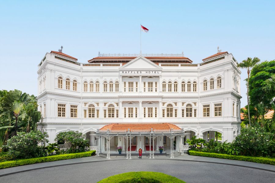 Exterior view of Raffles hotel in Singapore on a clear day.