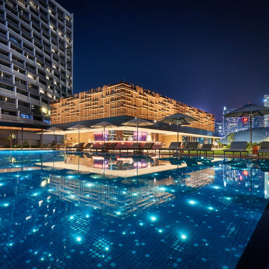 A view of the outdoor pool at night at ParkRoyal Collection Marina Bay Singapore.