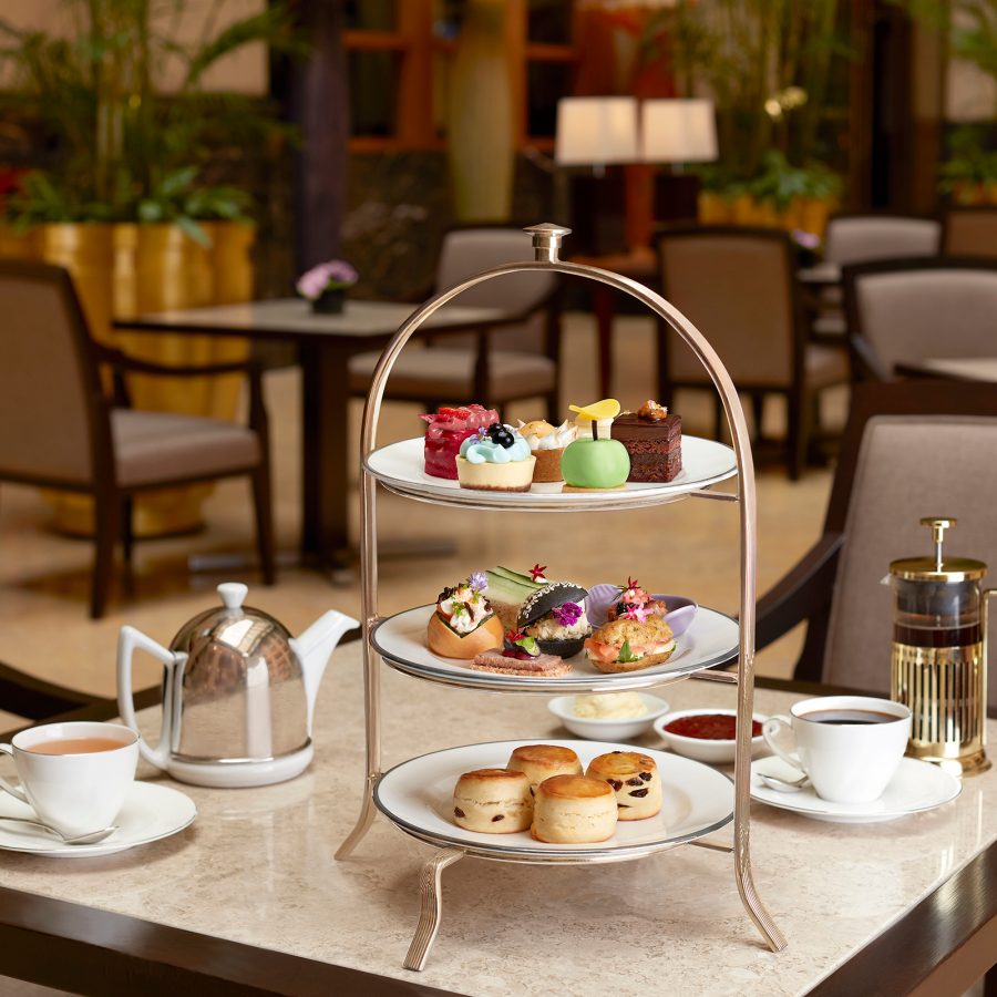 A high-tea tower of cakes and treats served with tea and coffee at The Fullerton Hotel in Singapore.