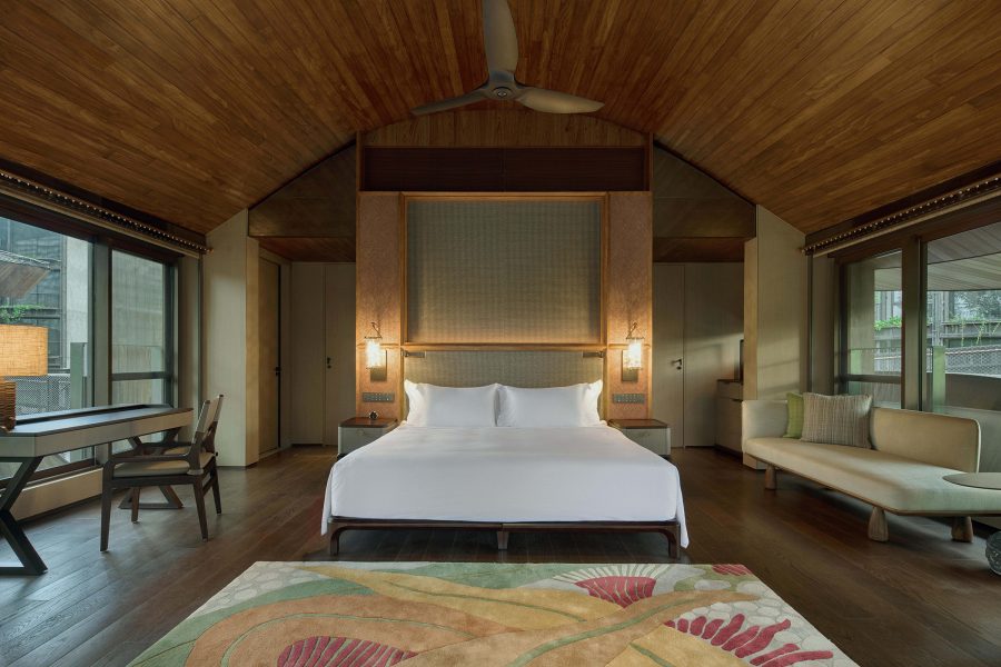 Interior view of nature-inspired bedroom suite featuring wooden interiors at Mandai Rainforest Resort by Banyan Tree in Singapore.