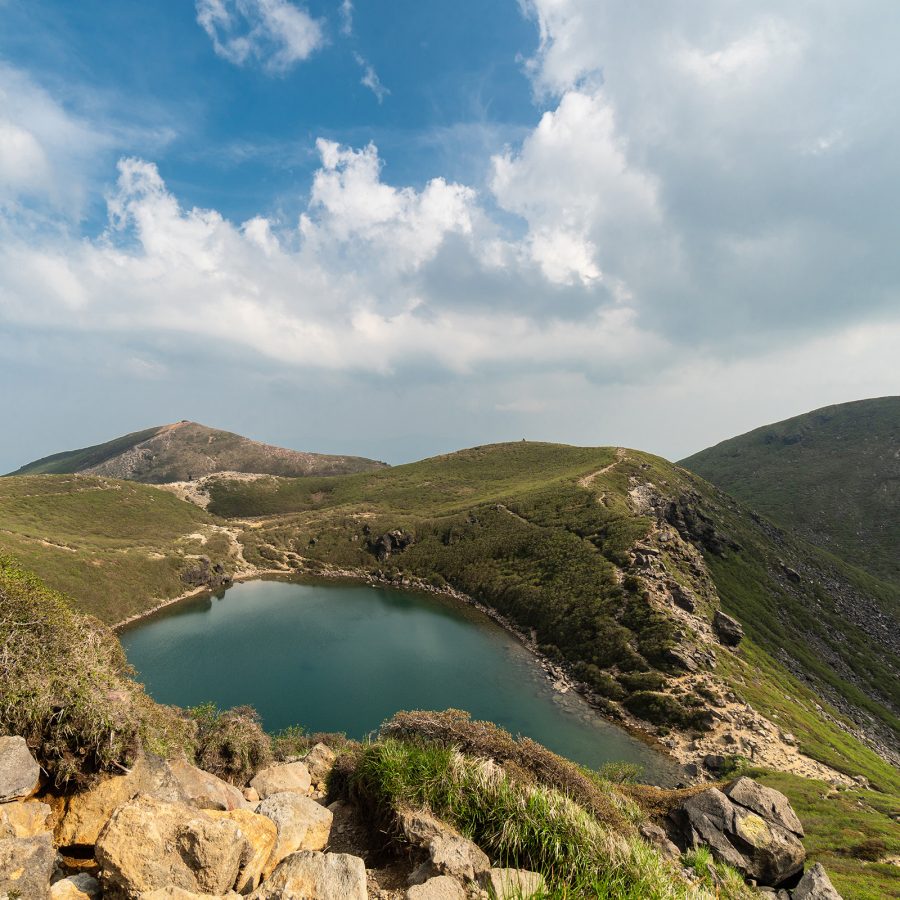 Scenic view of a lake in the distance from Mount Kuju.
