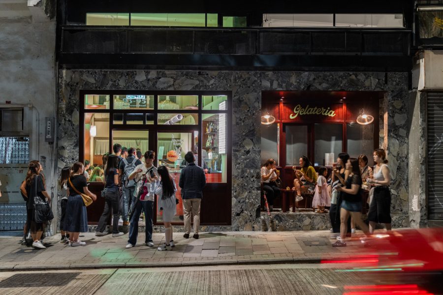 People line up outside Snack Baby gelateria at night. 