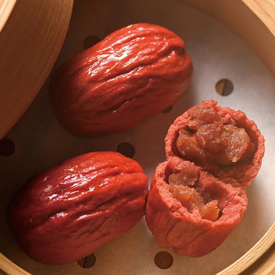 A flatlay image of steamed dates in a steamer basket.