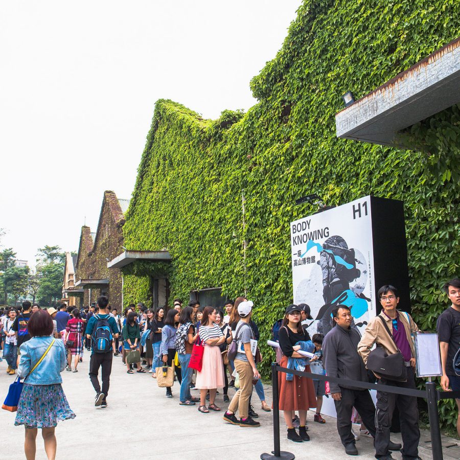 A crowd of people lining up infront of Huashan 1914 Creative Park in Taipei