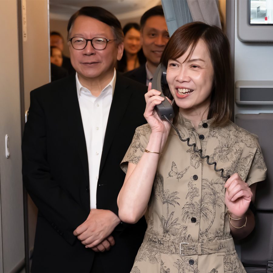 Cathay Chief Customer and Commercial Officer Lavinia Lau holding a phone onboard the I Can Fly Discovery Flight.