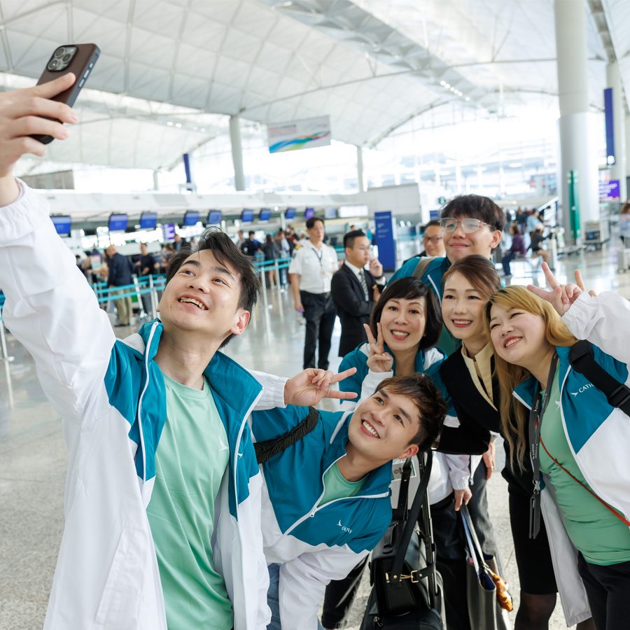 Participants of Cathay’s I Can Fly Discovery Flight taking a selfie at Hong Kong International Airport.