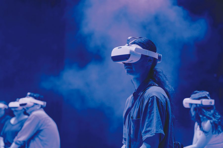 A man wearing a virtual reality headset with fog and other players in the background