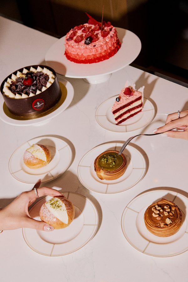 A plate of appealing pastries sit on a white table cloth ready to eat.