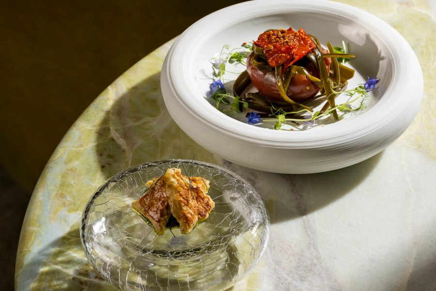 Two small plates sit on a shadowed table.