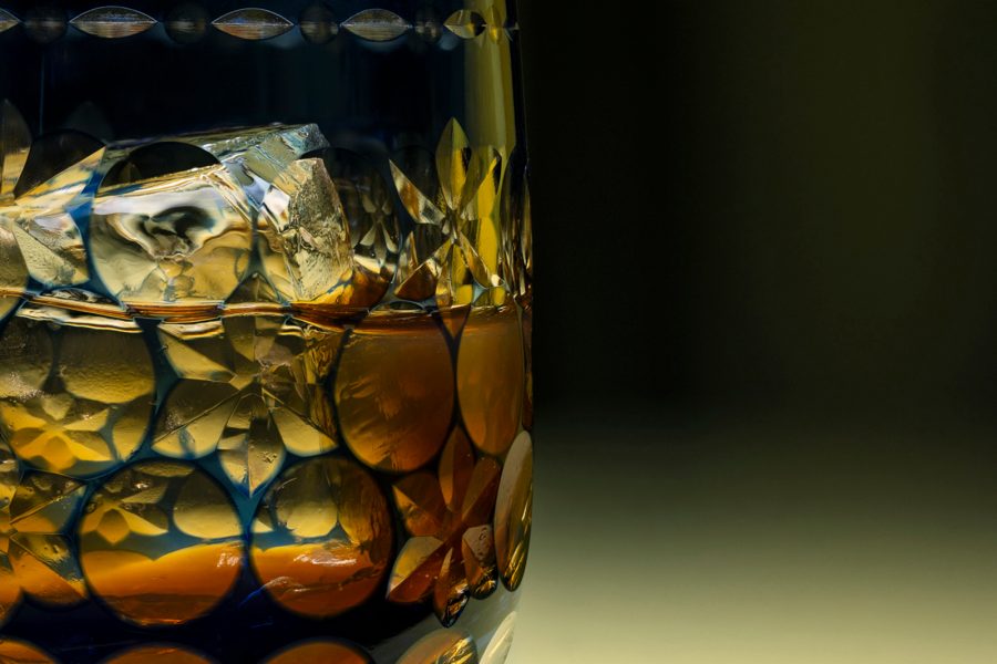 A whisky-based cocktail with a large ice cube.