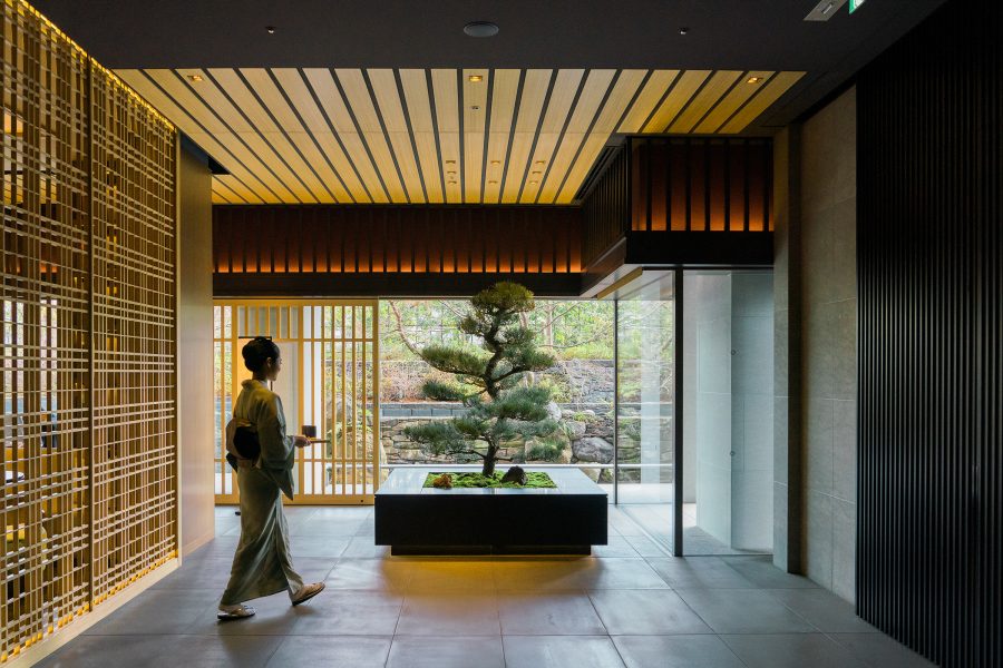 A woman wearing a kimono walking through the interiors of The Ritz-Carlton, Kyoto. 