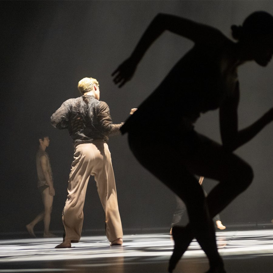 Modern dancers rehearse dramatic angular moves.