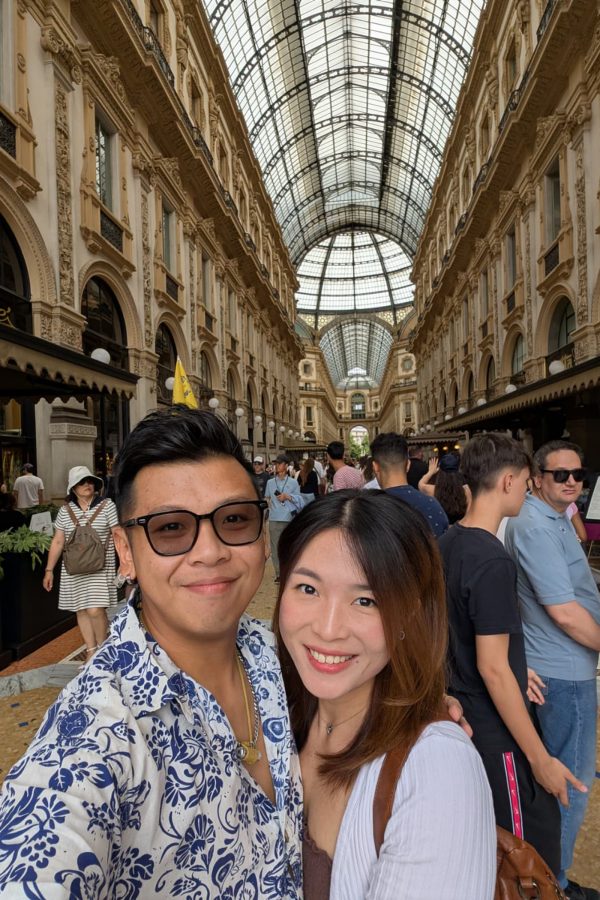A smiling couple inside Galleria Vittorio Emanuele II in Milan Italy. 