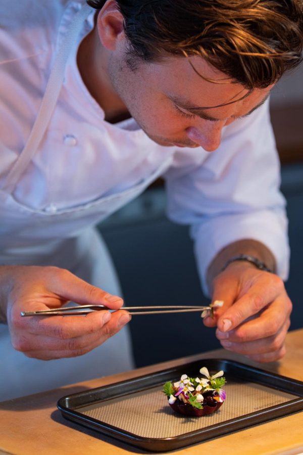 A chef at The Chef’s Table at Blue Duck Station plates a dish. 