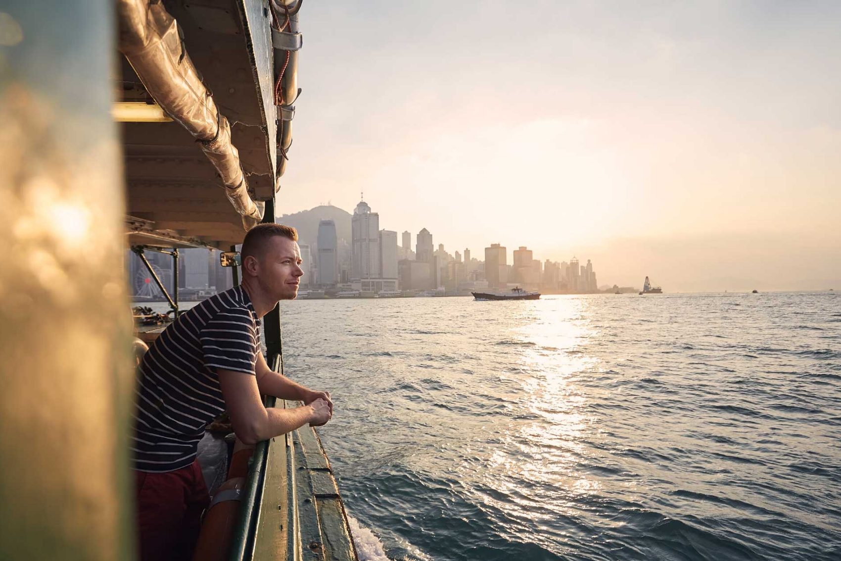 Man on star ferry looking over water. Credit: 123RF