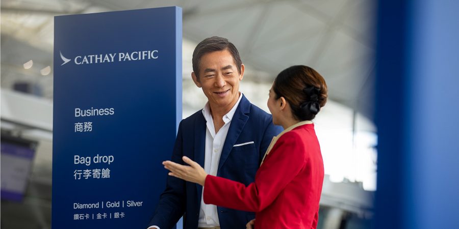 A Cathay Pacific Airport Services Agent assisting a passenger at Hong Kong International Airport 