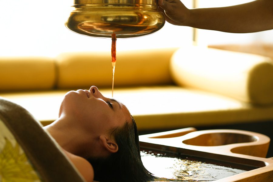 A woman relaxing to a spa treatment at Ananda in the Himalayas in Rishikesh, India