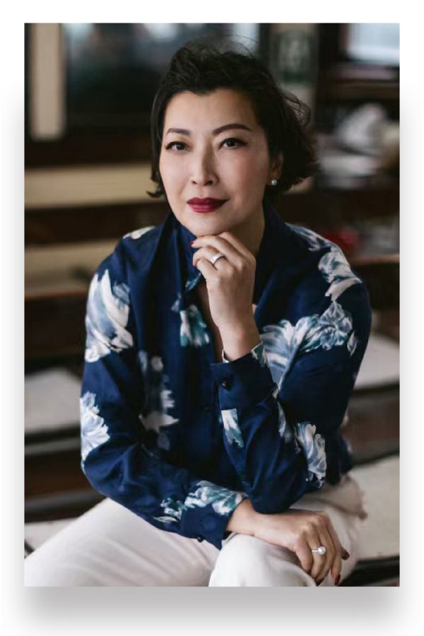 Carmen Chiu, Managing Director of Shanghai Tang, sits on the Star Ferry with her chin resting on her hand in Hong Kong.
