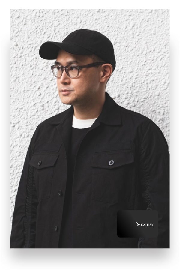  Federico ‘Fed’ Tan poses against a while wall in a baseball cap and glasses.